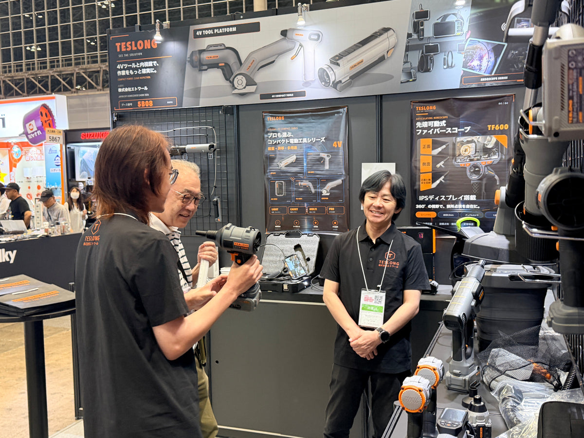 Product discussion at the Teslong booth with power tools and inspection equipment on display