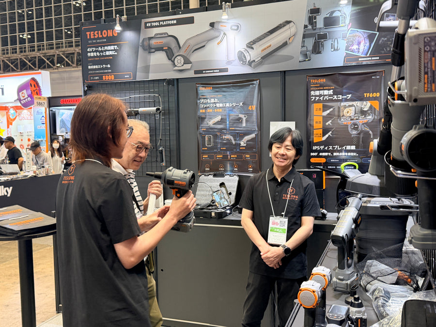 Product discussion at the Teslong booth with power tools and inspection equipment on display
