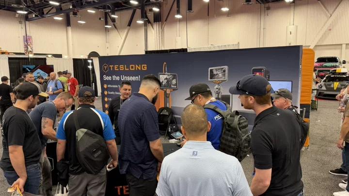 Visitors gathered around the Teslong booth
