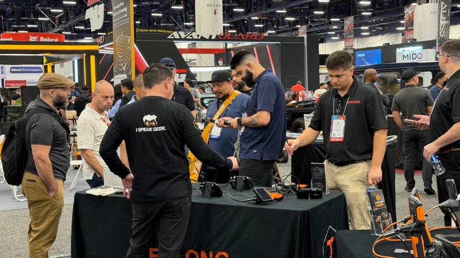 Visitors trying Teslong inspection cameras at SEMA 2025